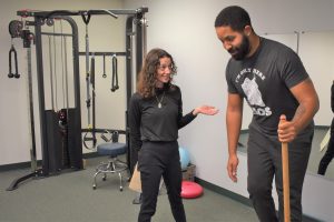 Siena coaches a client working on balance
